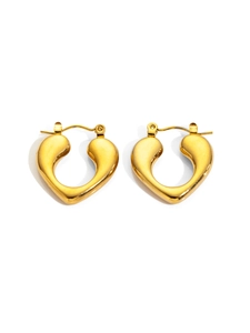 Macro detail of golden heart-shaped hoop earrings with polished metallic finish