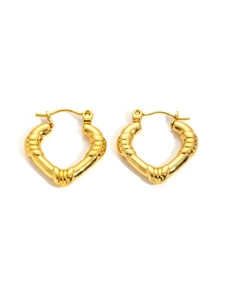 Macro detail of gold heart-shaped hoop earrings with textured bamboo spiral finish