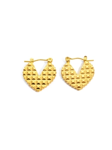 Macro detail of gold heart hoop earrings featuring a 3D pyramid geometric texture