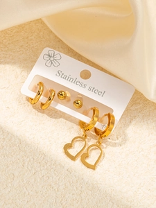 Detailed set of gold stainless steel earrings featuring hoops, studs, and heart charms