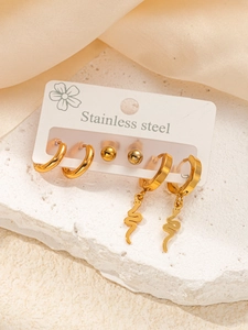 Detailed set of three golden stainless steel earrings featuring smooth hoops and snake charms
