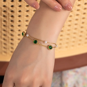 Double-layer vintage stainless steel gold bracelet with green zircon and pearls on wrist
