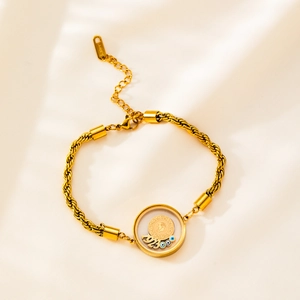 Detail of gold titanium steel rope chain bracelet with evil eye beads and coin charm