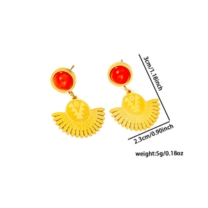 Close-up of vintage 18K gold plated butterfly fan earrings with orange gemstones