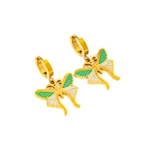 Detail of butterfly drop hoop earrings with green and white enamel on golden stainless steel