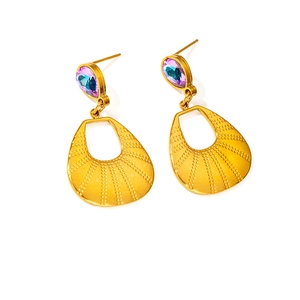 Detail of 18K gold butterfly earrings featuring colorful teardrop stones and textured metal