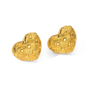 Detailed view of heart-shaped gold studs with textured woven metal surface and rivet details