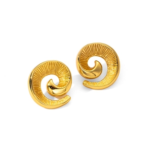 Macro detail of golden spiral stud earrings with radiant textures and a polished finish