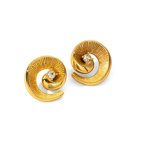 Detail of golden spiral stud earrings featuring a center rhinestone and radial texture