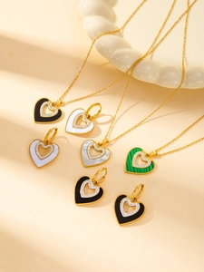 Macro detail of heart-shaped necklaces and earrings with crystal pavé and color inlays
