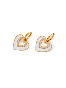 Detail of gold heart earrings with blue enamel, hollow design and sparkling crystals