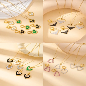 Elegant gold heart jewelry set including necklaces and earrings with shell and stone inlays