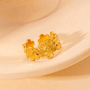 Macro shot of gold daisy flower patterns on a titanium steel adjustable ring