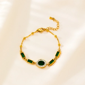 Macro detail of emerald-cut green crystal bracelet with gold-plated stainless steel chain