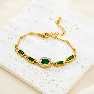 Elegant gold titanium steel bracelet featuring an oval emerald crystal and diamond accents