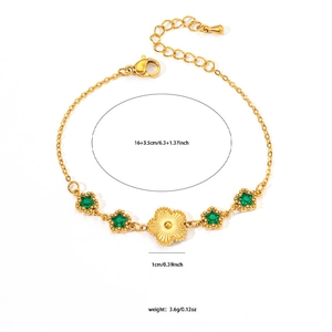Close-up of gold stainless steel bracelet with green star stones and floral charm detail