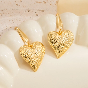 Lava textured 18k gold plated stainless steel heart dangle earrings in golden finish