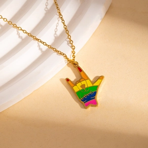 Close-up of golden necklace with rainbow ASL Love gesture pendant and colorful enamel detail