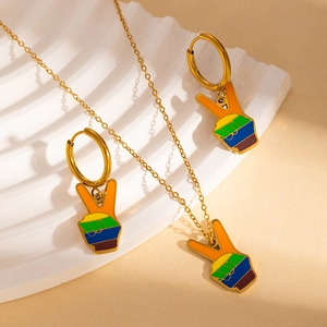 Detailed close-up of rainbow striped V-sign pendant necklace and gold hoop earrings