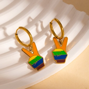 Detail of gold peace sign earrings featuring colorful rainbow striped enamel finish