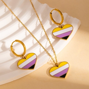 Detailed view of non-binary pride heart necklace and gold earring jewelry set