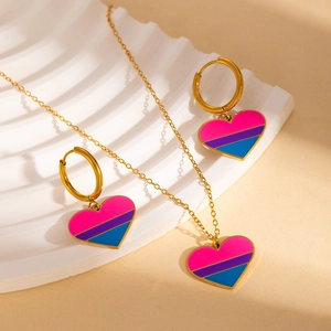 Macro detail of heart-shaped rainbow enamel necklace and matching earrings set