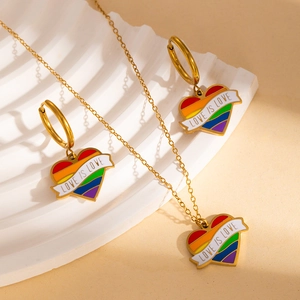 Detail of gold stainless steel heart necklace and earrings with rainbow Love Is Love design