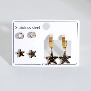Lot de trois paires de boucles d'oreilles étoile de mer en acier doré et émail noir