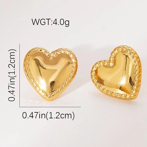 Macro shot of gold heart stud earrings featuring milgrain edges and polished finish