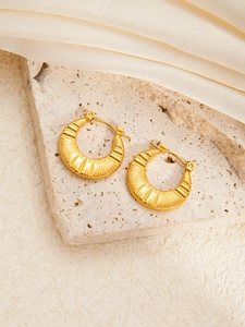 Golden crescent hoop earrings with textured finish and secure snap closure