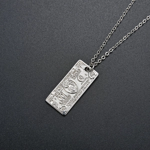 Detailed view of silver $100 dollar bill pendant with embossed hip hop style chain