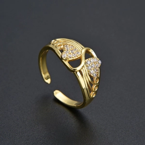 Macro shot of gold butterfly heart ring with cubic zirconia stones and adjustable open band