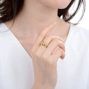 Gold open ring with heart cutout design and micro-pave crystals on a model finger