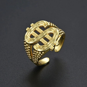 Detailed close-up of golden dollar sign ring with embossed dot texture on band