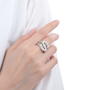 Close-up of hip hop dollar sign ring with sparkling white zircon pave on model finger