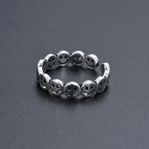 Detailed view of the vintage silver adjustable ring featuring a repeating smiley face design
