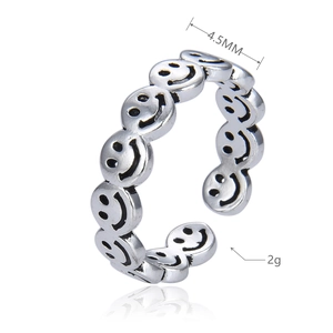 Detail showing the 4.5mm width and smiley face pattern of the vintage silver ring