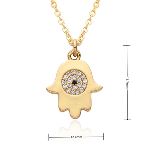 Detailed macro view of gold Hamsa Hand pendant with crystal evil eye and size dimensions