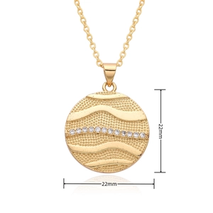 Detailed view of golden cupid round pendant with wave texture and white zircon stones