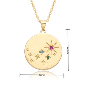 Detailed close-up of 22mm gold circular pendant necklace with sunburst and star gemstones