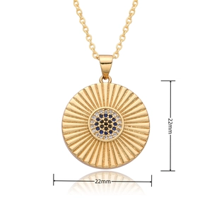 Detailed close-up of 22mm gold evil eye pendant with radial texture and blue zircon