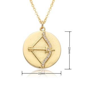 Macro view of 22mm golden round pendant with Sagittarius arrow design and cubic zirconia