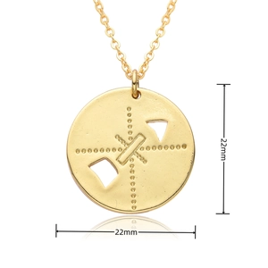 Detailed macro view showing a 22mm golden round pendant with embossed hollow design