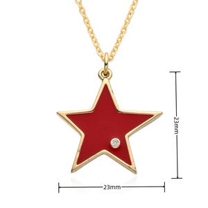 Detailed view of gold plated star pendant with red enamel inlay and tiny zircon stone