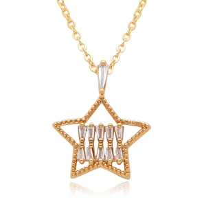Macro view of gold star pendant necklace featuring baguette zircon center and milgrain edge
