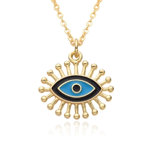 Minimalist evil eye pendant necklace with blue enamel and gold-plated finish on white background
