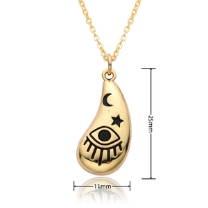 Detail view of gold teardrop pendant with celestial eye, moon and star motifs, 25mm height