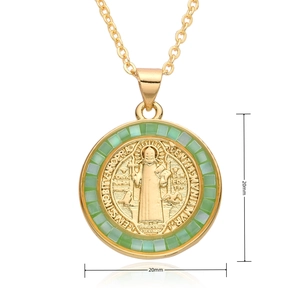 Detail of a 20mm round Virgin Mary pendant with green cubic zirconia and gold plating