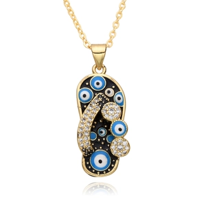 Detailed close-up of a flip-flop pendant necklace featuring evil eye motifs and crystals
