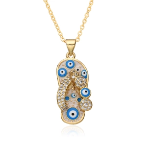 Macro shot of flip-flop pendant with evil eye enamel and cubic zirconia in gold finish